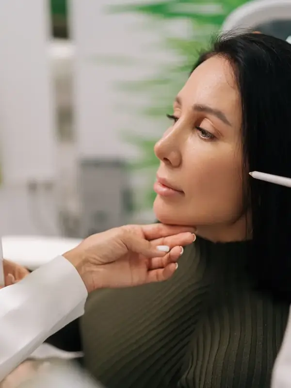 Surgeon marking a woman's face before eyelid surgery