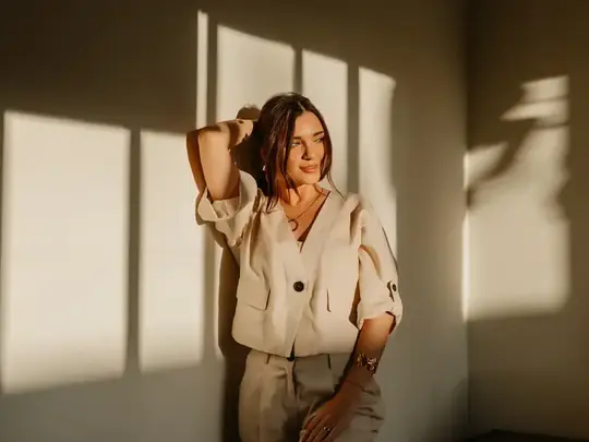 Woman relaxing at home in warm sunlight