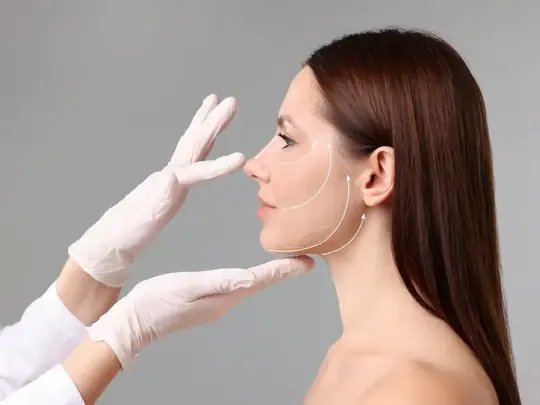 Surgeon planning a facial procedure with marking lines